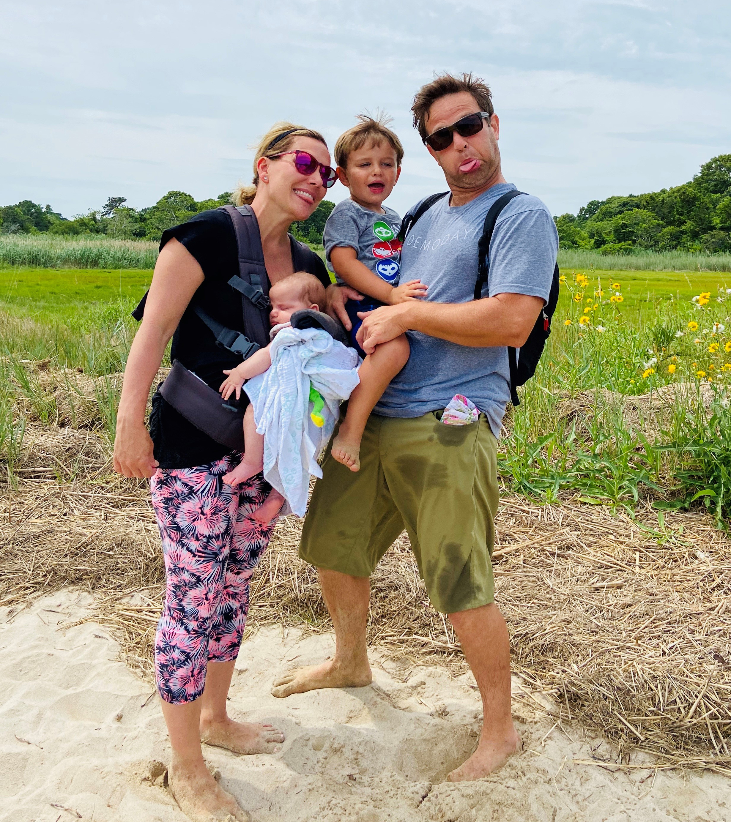 Kimm Dinsmore and family sticking their tongues out while on the beach